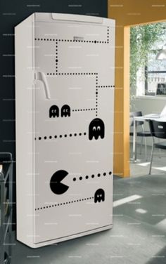 a white refrigerator freezer sitting inside of a kitchen next to a dining room table