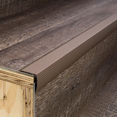 a close up view of the side of a wood flooring board with an unfinished edge