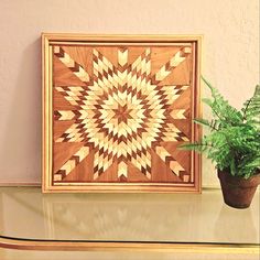 a potted plant sitting on top of a glass table next to a wooden frame