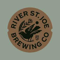 the logo for river st joe brewing co is brown and black on a green background