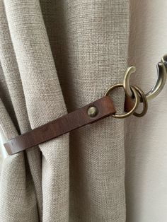 a close up of a curtain with a metal ring on it