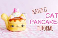 a small toy cat with a cupcake on it's head and the words kawaii cat pancakes