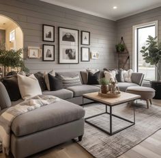 a living room filled with furniture and pictures on the wall