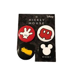 two mickey mouse buttons are shown in front of a package with an image of mickey mouse