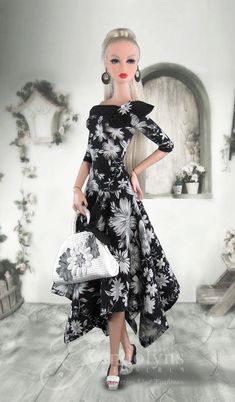 a barbie doll wearing a black and white dress