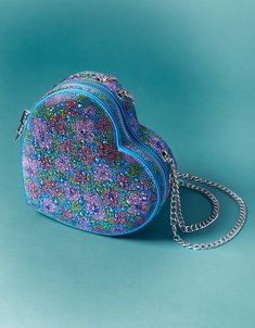 Fall in love with our STONE HEART CONVERTIBLE BAG! This rhinestone floral crossbody bag is shaped like a heart, adding a touch of romance to any outfit. Perfect for a night out or everyday use, it's a unique and playful accessory. Manmade materials with stones Convertible shoulder to crossbody strap 7.55"L x 2.25"D x 7.09"H Imported Unusual Handbags, Heart Purse, Betsey Johnson Purses, Happy Stuff, Embroidery Hearts, Second Account, Diy Rhinestone, Convertible Bags, Heart Bag