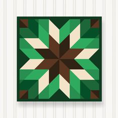 a green, brown and white geometric design on a wall