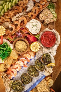 an assortment of food is laid out on a table with different types of foods and sauces