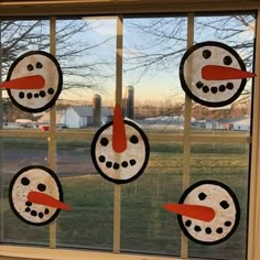 a window with four snowmen on it