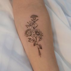 a woman's arm with flowers on it