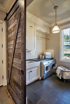 an open door leading to a kitchen with a washer and dryer