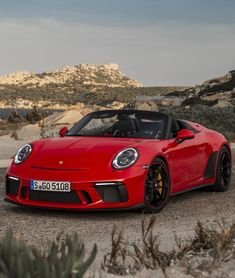 a red sports car parked in the desert