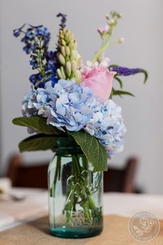 a vase filled with blue flowers on top of a table