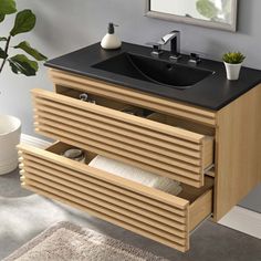 a bathroom vanity with drawers and a sink