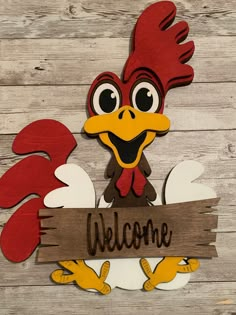 a wooden sign with a rooster holding a welcome sign