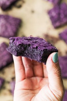 a person holding up a purple rock in their hand