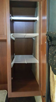 the inside of a small closet with shelves