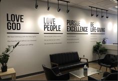 the office is decorated with black and white wall decals that say love, praise, excellence, life - giving