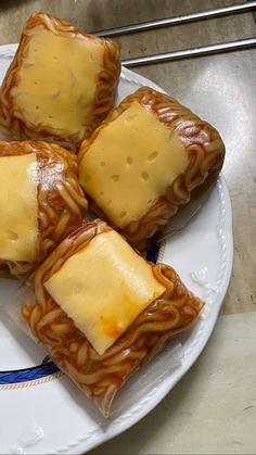 four pieces of chinese food on a plate