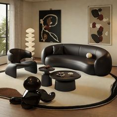 a modern living room with black leather furniture and large art work on the window sill