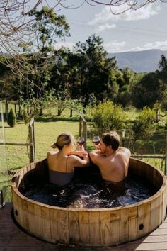 two people sitting in an outdoor hot tub