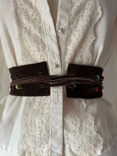 This piece has been in my collection for at least twenty years. It's a genuine 1970s fringed beaded belt made out of supple brown suede leather. Can be tied in a multitude of different ways. All original beads are intact except one is missing from one piece of fringe. The thick part of the band is 27 inches long and 2.5 inches wide. Can also be worn over the shoulders or as a head band.  (Blouse not included.) Important note on refunds and returns: Due to past fraudulent orders, we cannot accept Bohemian Brown Belt For Festival, Bohemian Brown Rope Belt, Vintage Handmade Brown Belt, Adjustable Brown Beaded Belt, Adjustable Beaded Brown Belt, Long Fringe, Long Fringes, Beaded Belt, Vintage Suede