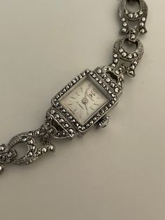 Elegant Art Deco marcasite Bucherer Swiss wristwatch in good working condition. A beautiful silver case with marcasites. The sparkling marcasites give the watch a unique look.  Mechanical hand winding 17 jewel movement. Beautiful Bucherer silver-tone dial with silver-tone markers. Beautiful silver marcasite bracelet band with safety chain. This watch is NOT sterling silver it is a base metal. Making a beautiful timepiece easily affordable with all the glitz . Silver Diamond Watch With Diamond Accents As Gift, Vintage Silver Bracelets, Antique Silver Jewelry And Watches For Formal Occasions, Classic Silver Jewelry And Watches For Evening, Antique Silver Jewelry And Watches For Anniversary, Antique Silver Jewelry And Watches For Evening, Silver Vintage Diamond Watch For Anniversary, Antique Silver Diamond Watch For Anniversary, Silver Vintage Diamond Watch For Formal Occasions