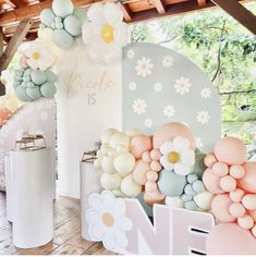 balloons and flowers are on display at a wedding reception in an outdoor pavilion with the word made is written above them