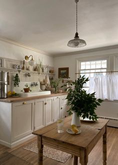 a kitchen filled with lots of counter top space next to a wooden dining room table