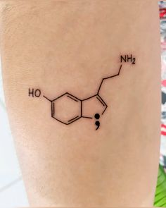 a woman's tattoo with the chemical formula