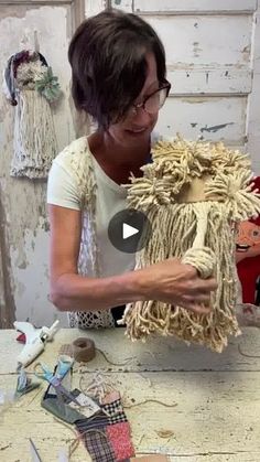 a woman is working on a sculpture with yarn