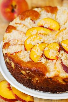 a close up of a cake on a plate with peaches and other toppings