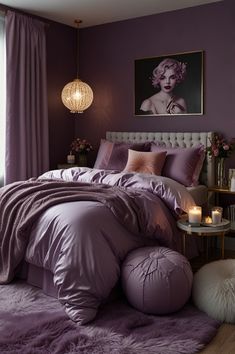 a bedroom with purple bedding and candles on the side table in front of it