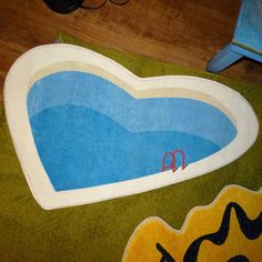 an oval shaped rug with a pool in the middle