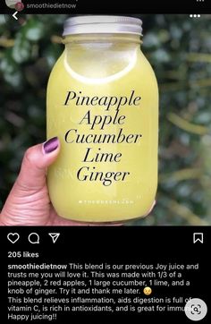 someone is holding up a jar of pineapple apple cucumber ginger in their hand