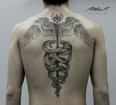 the back of a man with a snake and wings tattoo on his upper body,