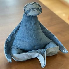 a stuffed animal sitting on top of a wooden table