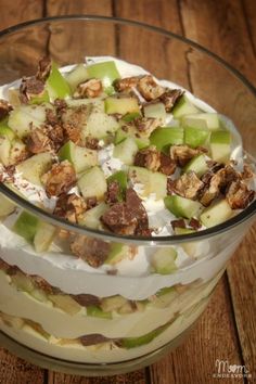 a glass bowl filled with fruit and nuts