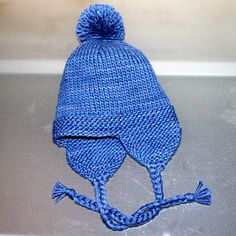 a blue knitted hat sitting on top of a counter