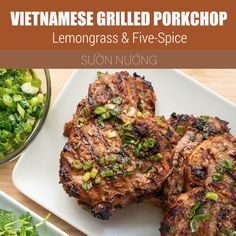 grilled pork chops with lemongrass and five - spice sauce on a white plate