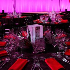 the table is set up with red napkins and place settings for guests to eat