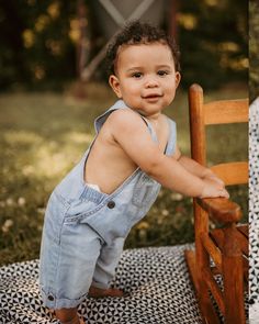 a little boy that is sitting in a chair