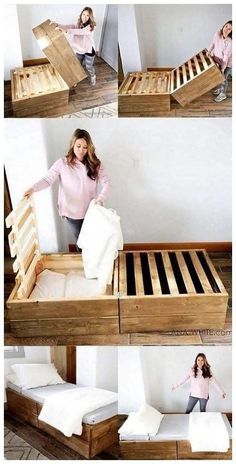 a woman standing on top of a wooden bed frame with mattresses and pillows in it