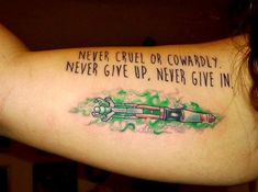 a woman with a tattoo on her arm that says never cruel or comparaily never give up never give in