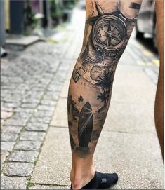 a man with a tattoo on his leg is walking down the street