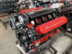 a red engine sitting on top of a metal stand