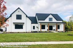 a large white house with black roof and windows