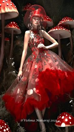 a woman in a red dress standing next to mushrooms