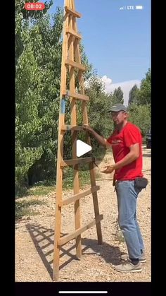 a man standing next to a wooden ladder