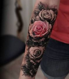 a woman's arm with roses on it